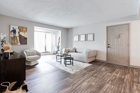 a living room with white couches and a coffee table